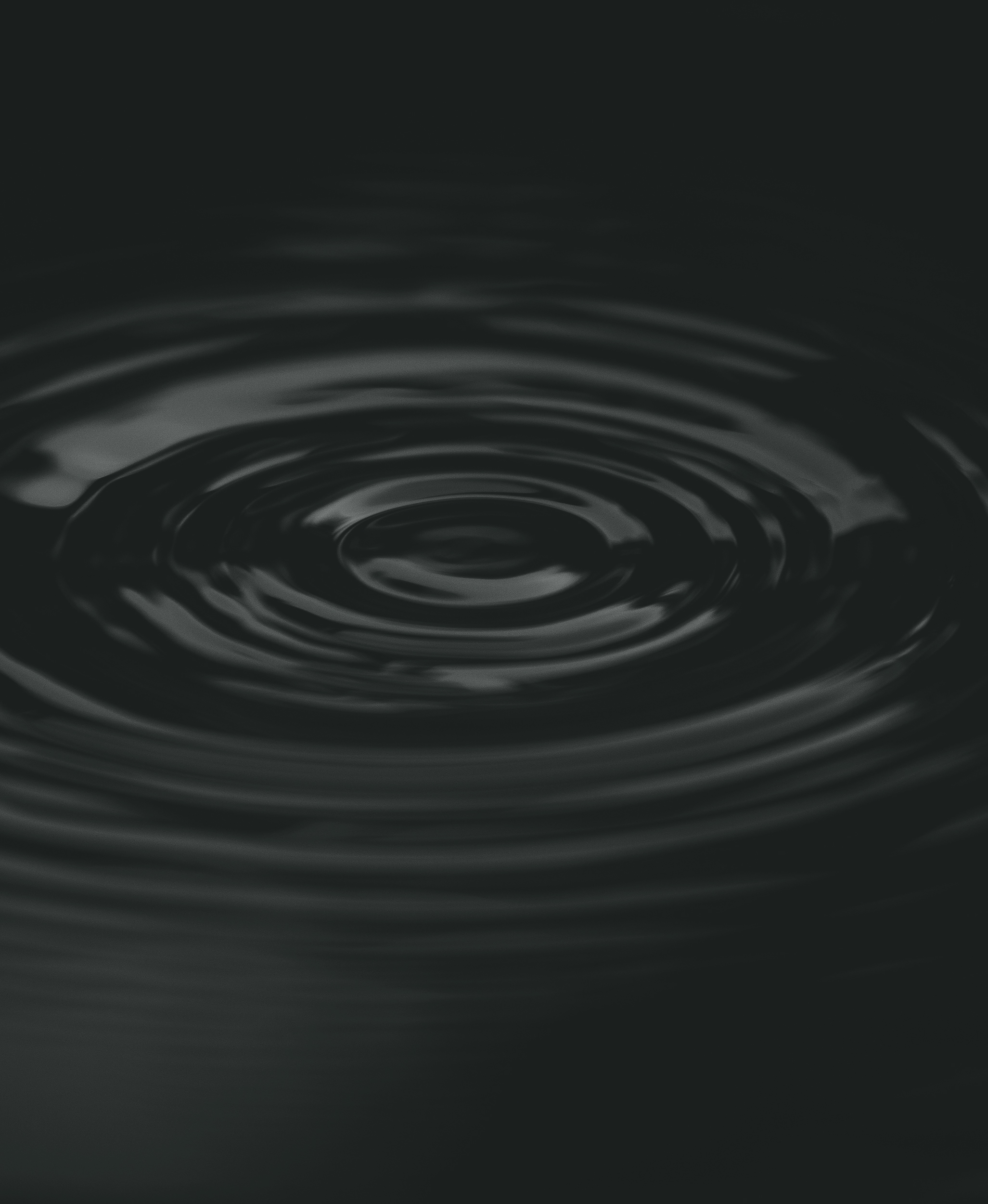 Ripple of water or water drop splash on black background. Abstract shape out of the water